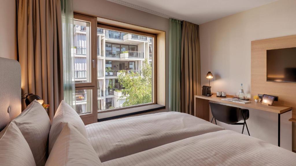 Postel nebo postele na pokoji v ubytování Hotel the YARD Berlin