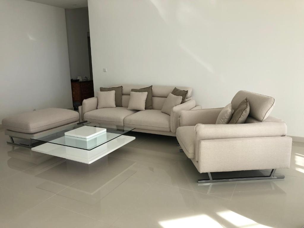 a living room with two couches and a coffee table at Magnifique Appartement Vue Mer in Vallauris