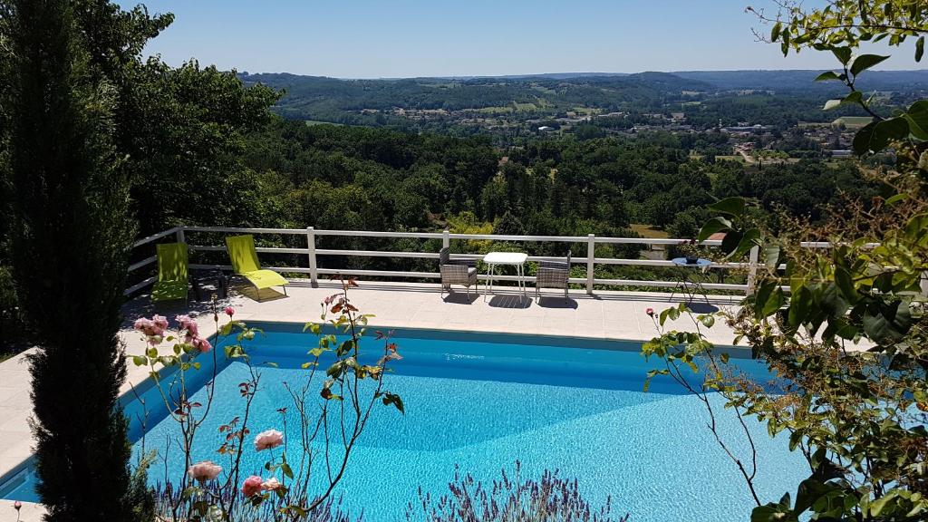 a swimming pool with a view of a mountain at le clos des etoiles B&B in Le Bugue