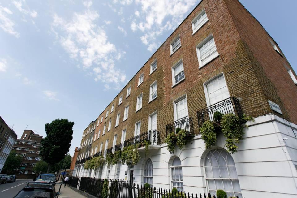 a large brick building with plants on the side of it at Studios2Let - North Gower in London