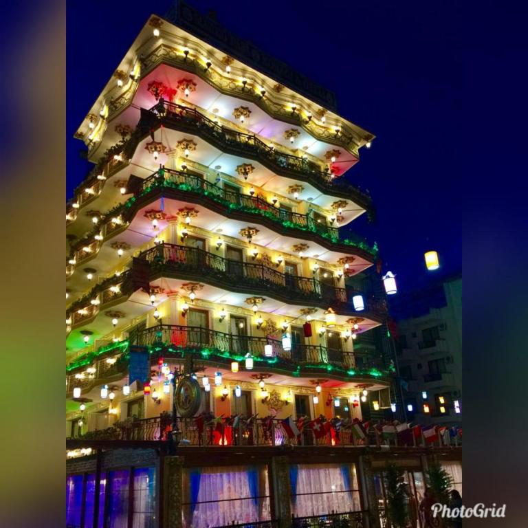 a tall building with christmas lights on it at MARKO PASA KONAGİ in Kuşadası