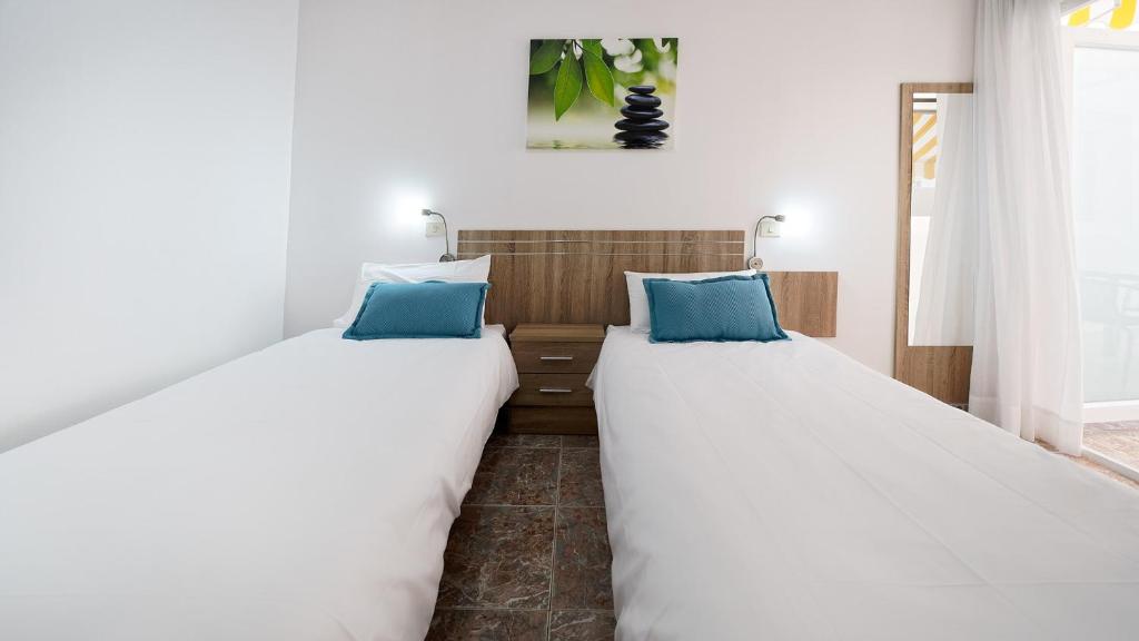two beds sitting next to each other in a room at Armonía Beach 17 in Arinaga