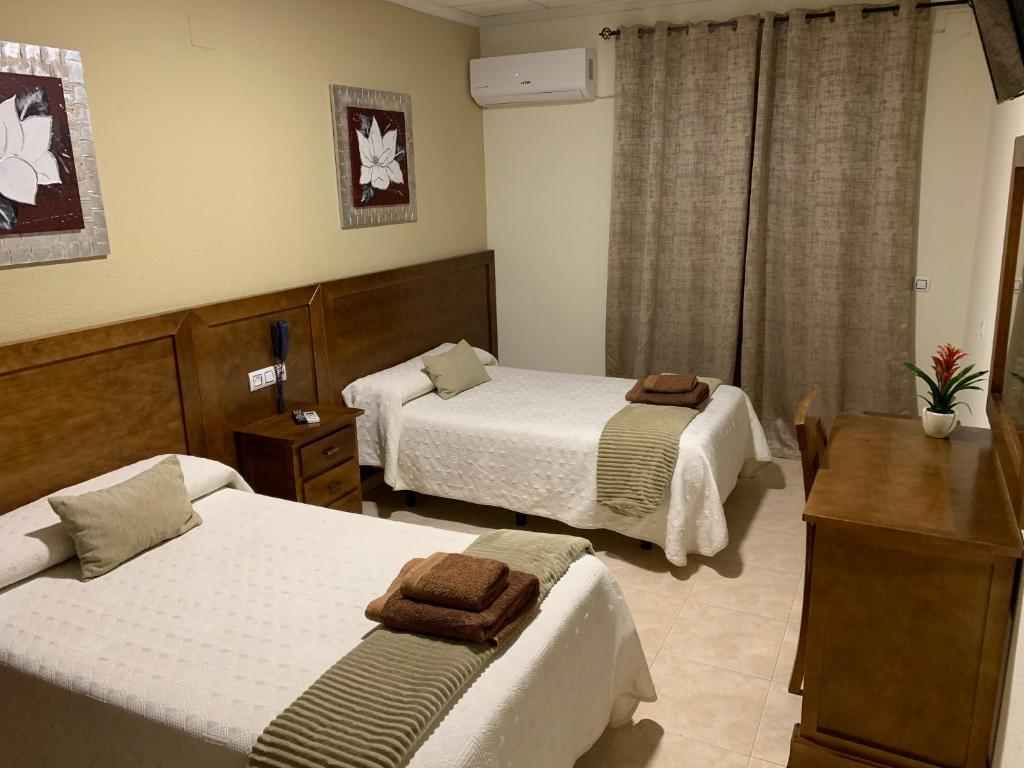 Postel nebo postele na pokoji v ubytování Hotel Don Juan