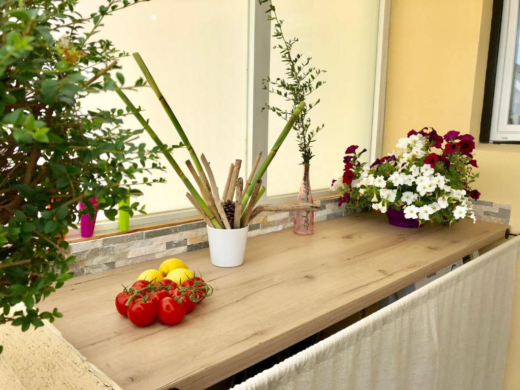 a table with fruits and flowers on a window sill at Appartement Cosy Calme Central-Terrasse Proche Palais in Cannes