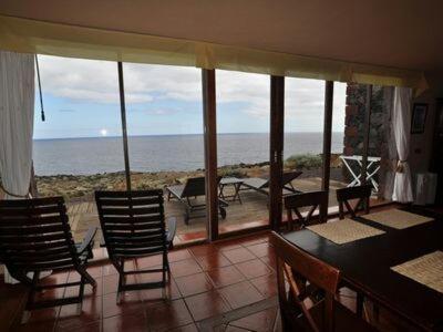 a dining room with a view of the ocean at casa La Perdiz in Valverde