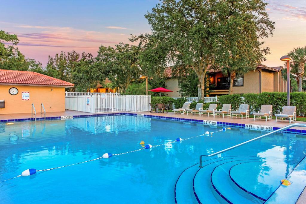 a swimming pool at a resort with blue water at Alhambra Villas in Kissimmee