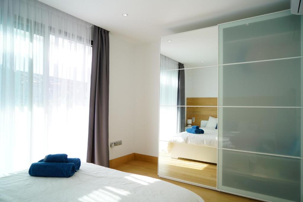 a bedroom with a bed and a large glass wall at Luxury Villa in Los Cristianos in Arona