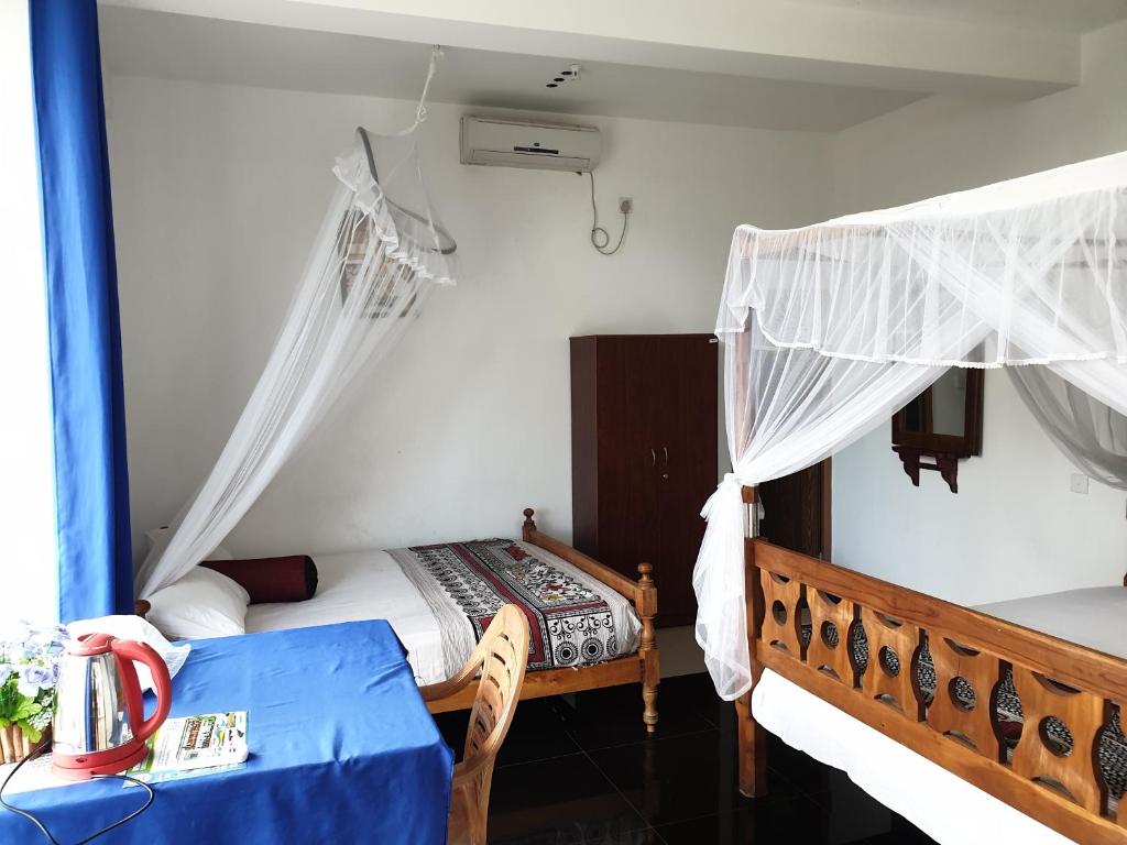 Postel nebo postele na pokoji v ubytování Liyanage Resort