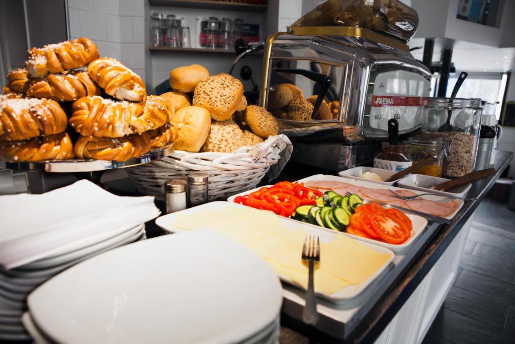 a buffet with bread and vegetables on a table at City Backpackers Hostel in Stockholm