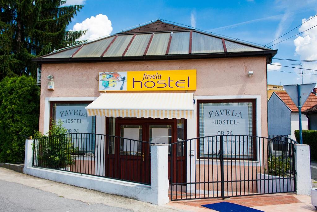 a house with a sign on the front of it at Favela Hostel in Zagreb