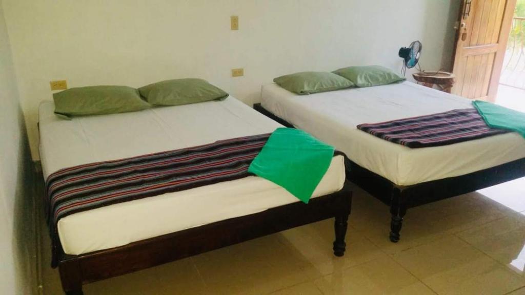 Postel nebo postele na pokoji v ubytování Hotel & Hostal Yaxkin Copan