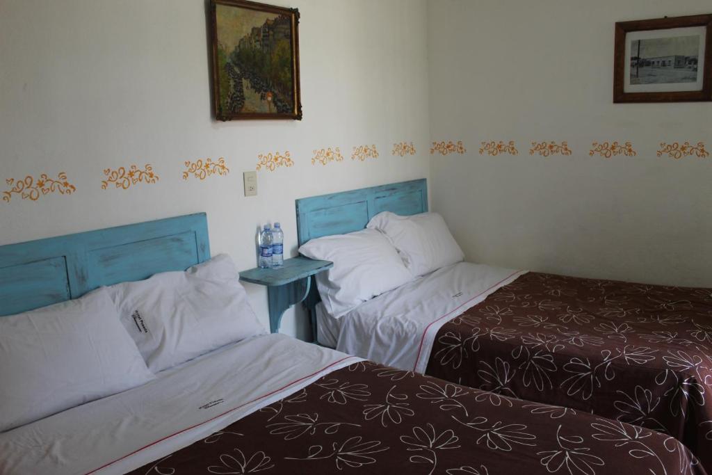 Postel nebo postele na pokoji v ubytování Hotel Posada Chamacuero