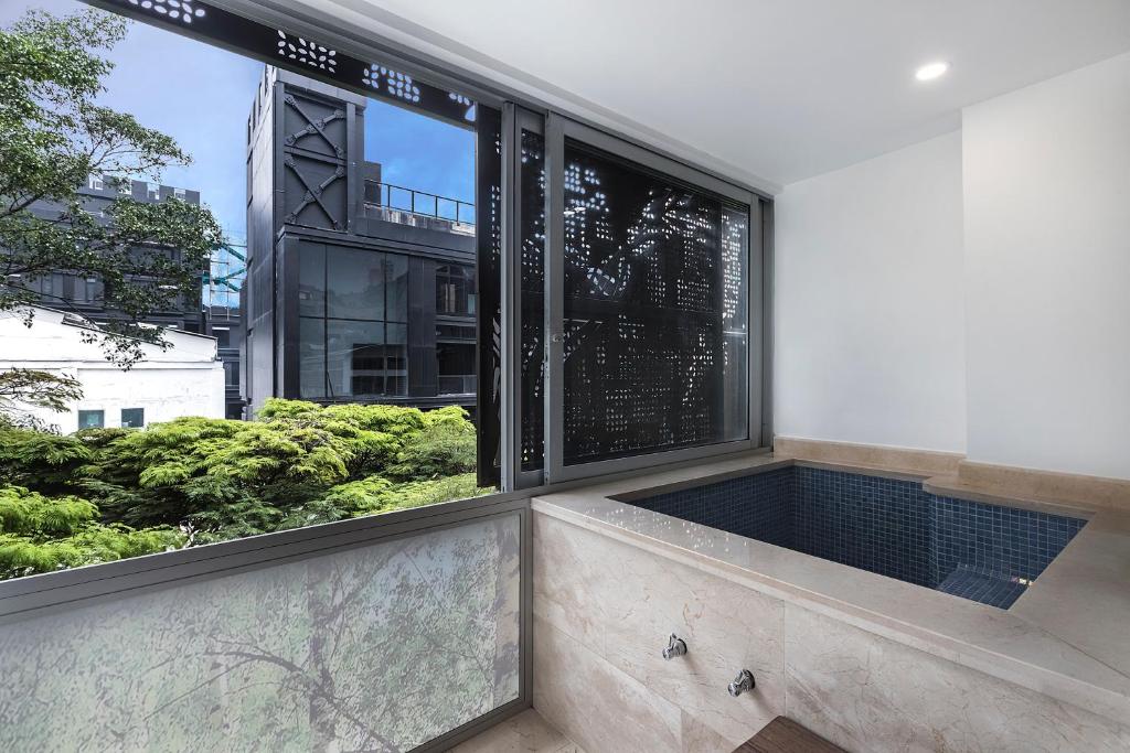 a large window with a view of a building at Hotel Madeiro in Medellín