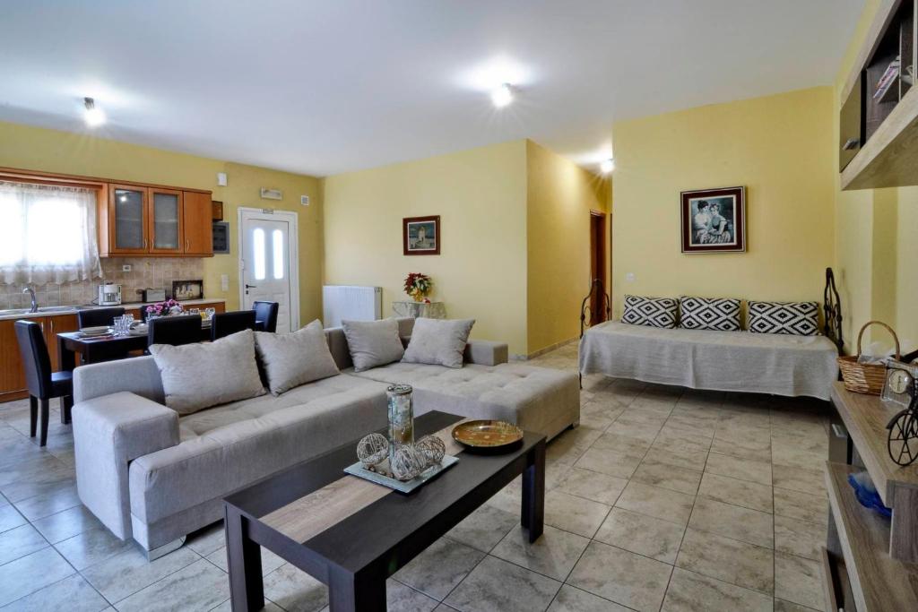 a living room with a couch and a table at Vasos Apartment Agios Athanasios Corfu in Agrós