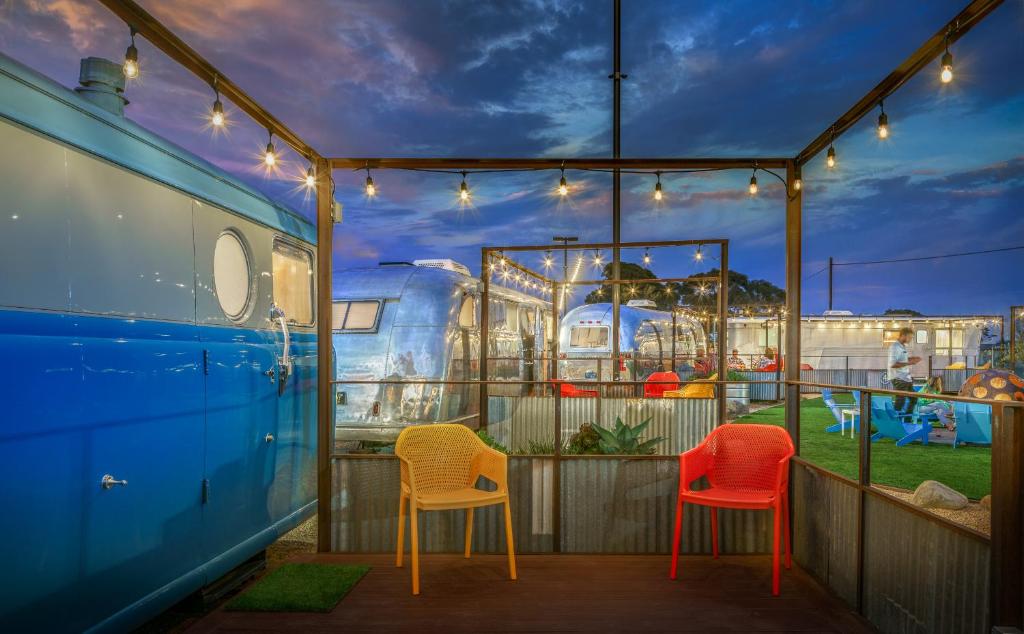 three chairs sitting on a patio with a water park at Waypoint Ventura in Ventura