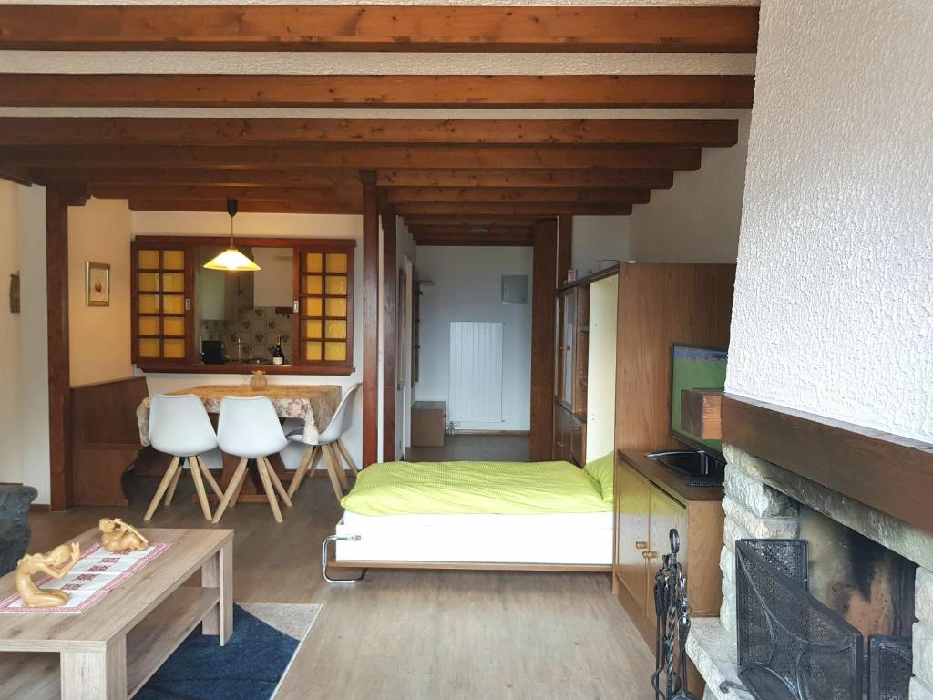a living room with a bed and a fireplace at Clabina 31 in Leukerbad