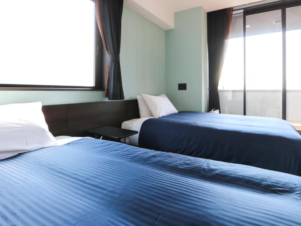 Postel nebo postele na pokoji v ubytování HOTEL LiVEMAX Asakusabashi-Eki Kitaguchi