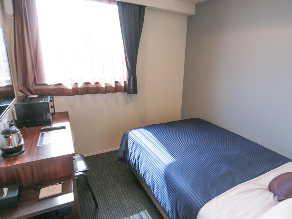 Postel nebo postele na pokoji v ubytování HOTEL LiVEMAX Tokyo Ayase-Ekimae