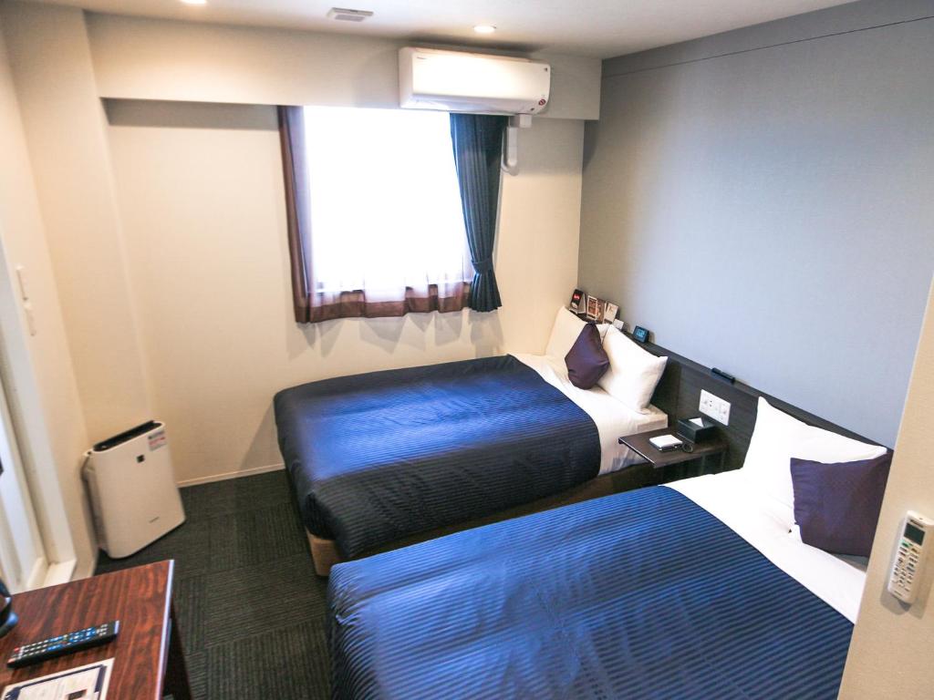 Postel nebo postele na pokoji v ubytování HOTEL LiVEMAX Tokyo Ayase-Ekimae