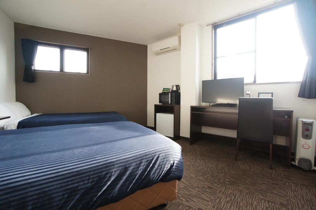 Postel nebo postele na pokoji v ubytování HOTEL LiVEMAX BUDGET Gunma Numata