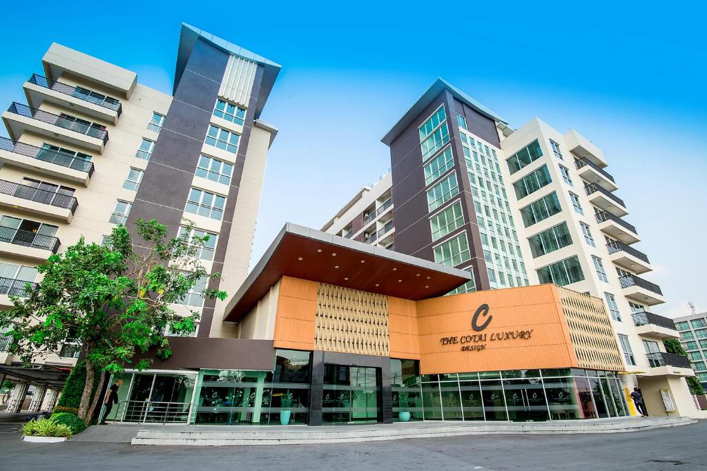 a building in front of two tall buildings at The Cotai Luxury Design Hotel in Bang Bo