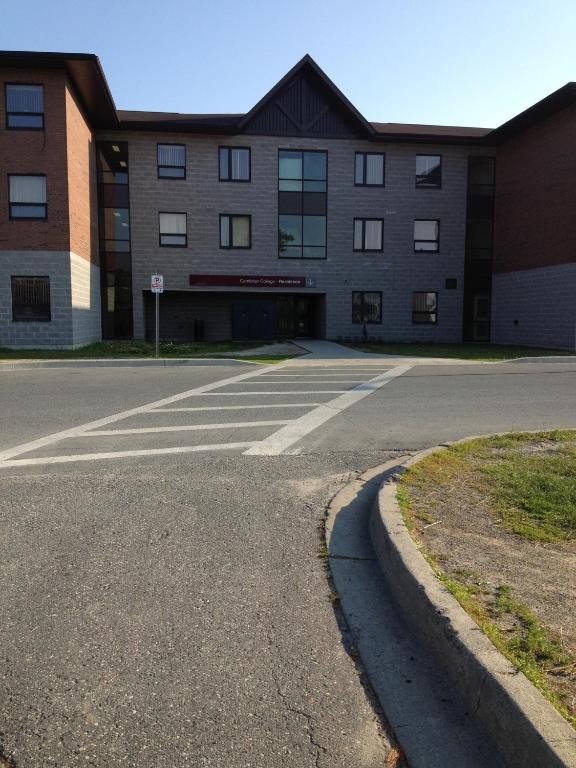 an empty parking lot in front of a building at Residence & Conference Centre - Sudbury North in Sudbury