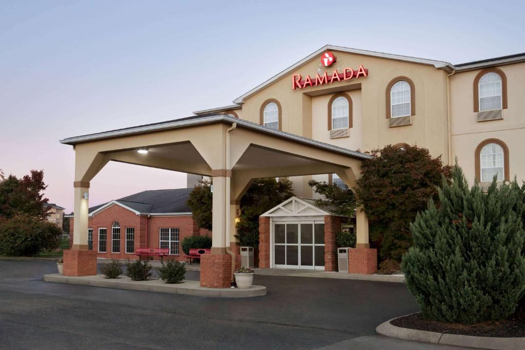 a building with a sign for a hampton inn at Ramada by Wyndham Elizabethtown in Elizabethtown