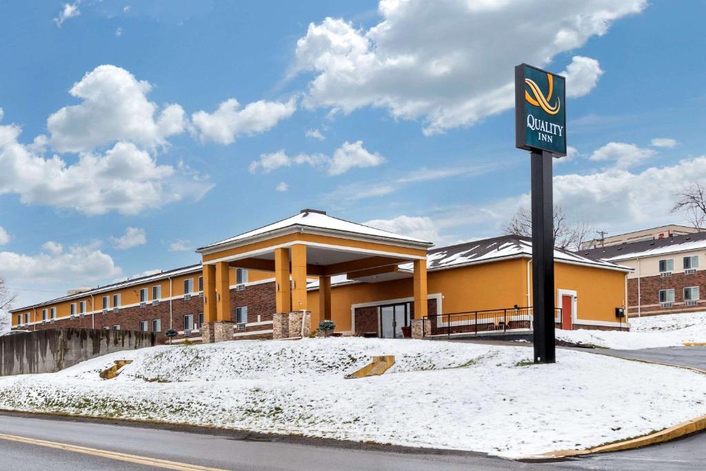 a sign in front of a building in the snow at Quality Inn Coraopolis in Coraopolis