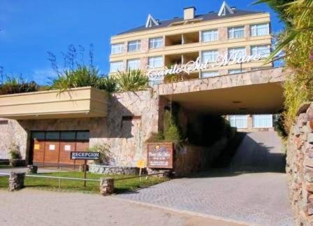 a large building with a sign in front of it at Cariló Sul Mare in Carilo