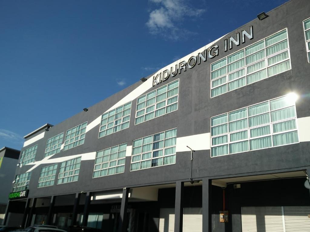 a building with a sign on the side of it at Kidurong Inn in Bintulu