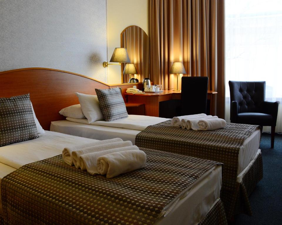 Postel nebo postele na pokoji v ubytování Hotel Orion Várkert
