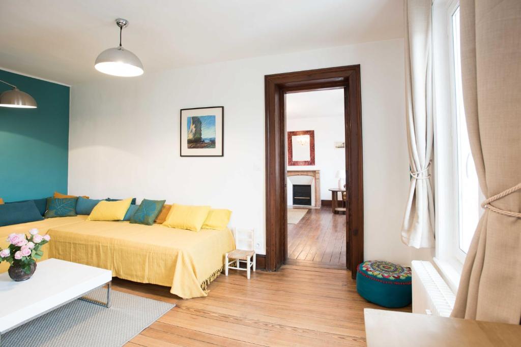 a bedroom with a bed and a living room at Le Tout à Pied et son parking privé in Étretat