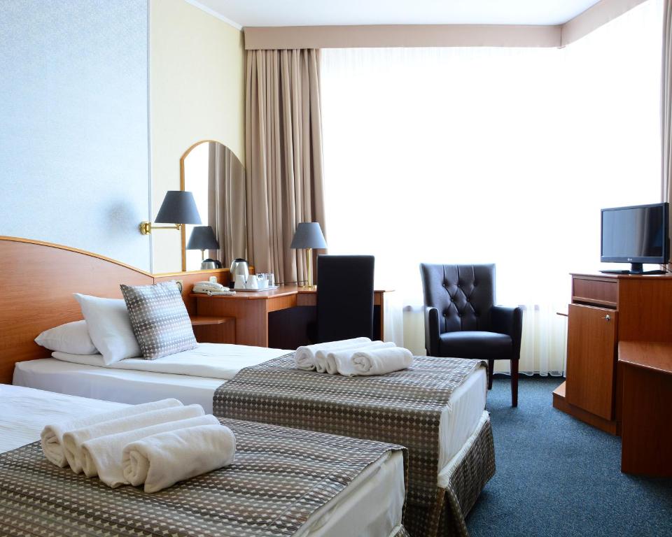 Postel nebo postele na pokoji v ubytování Hotel Orion Várkert
