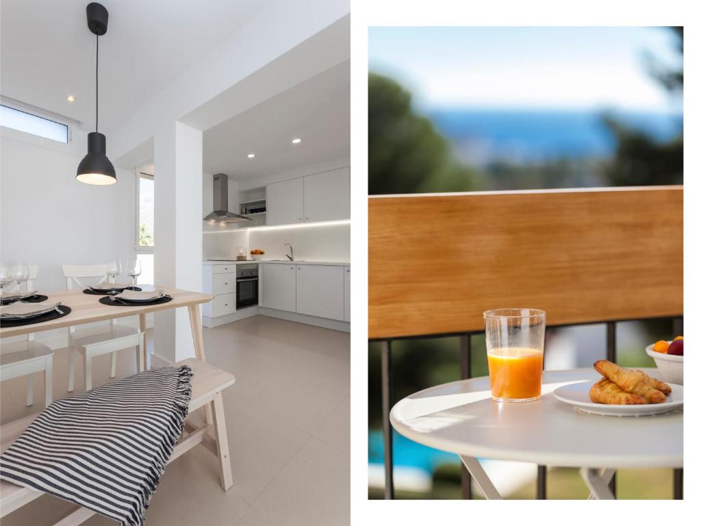 マルベーリャにあるSeaview flat with Sunny Balcony - Central Marbellaの白いキッチン(オレンジジュース1杯付きのテーブル付)