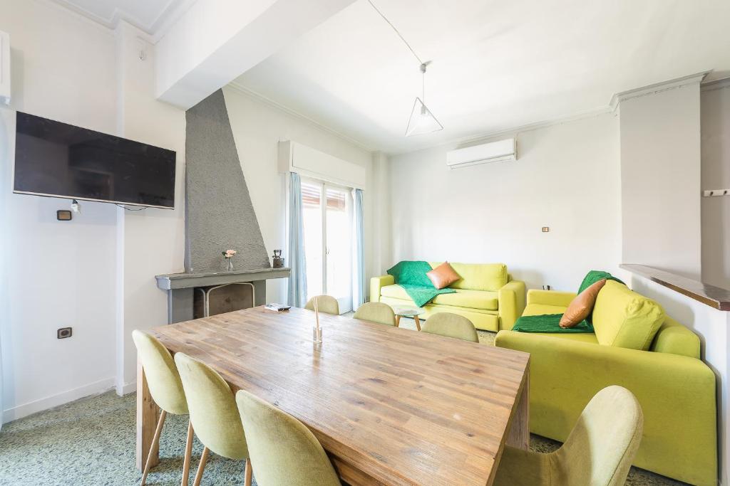 a living room with a table and a couch at Space Paradise Apartments in Athens