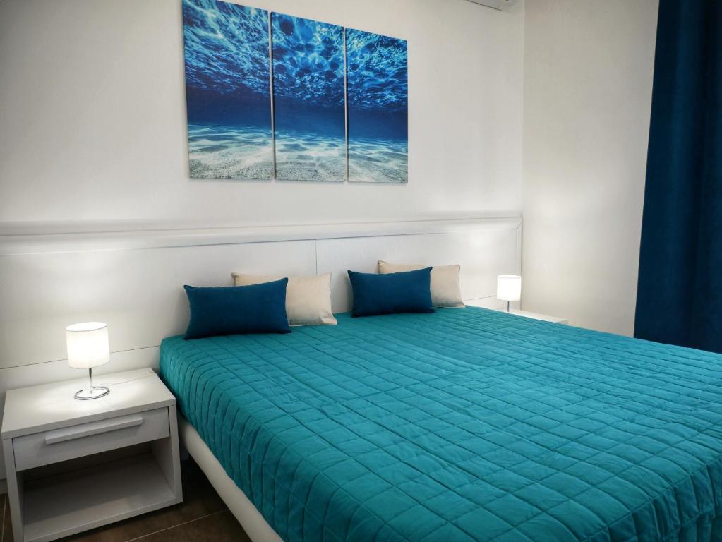 Posteľ alebo postele v izbe v ubytovaní Denza Apartments
