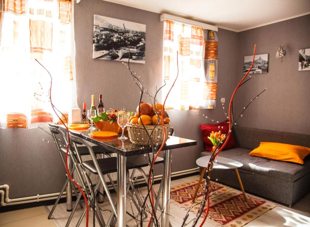 a living room with a table with fruit on it at Apartment Ritz Street in Tbilisi City