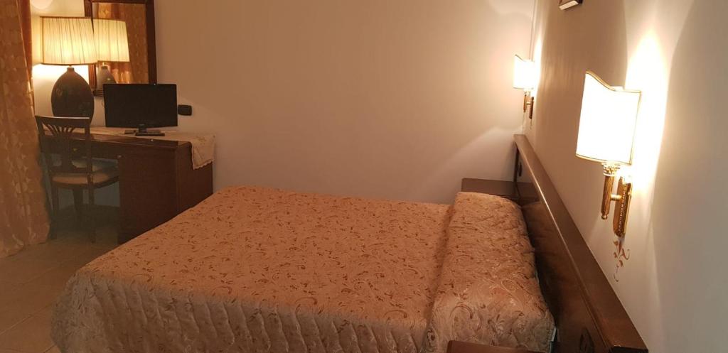Postel nebo postele na pokoji v ubytování Hotel Vitalba