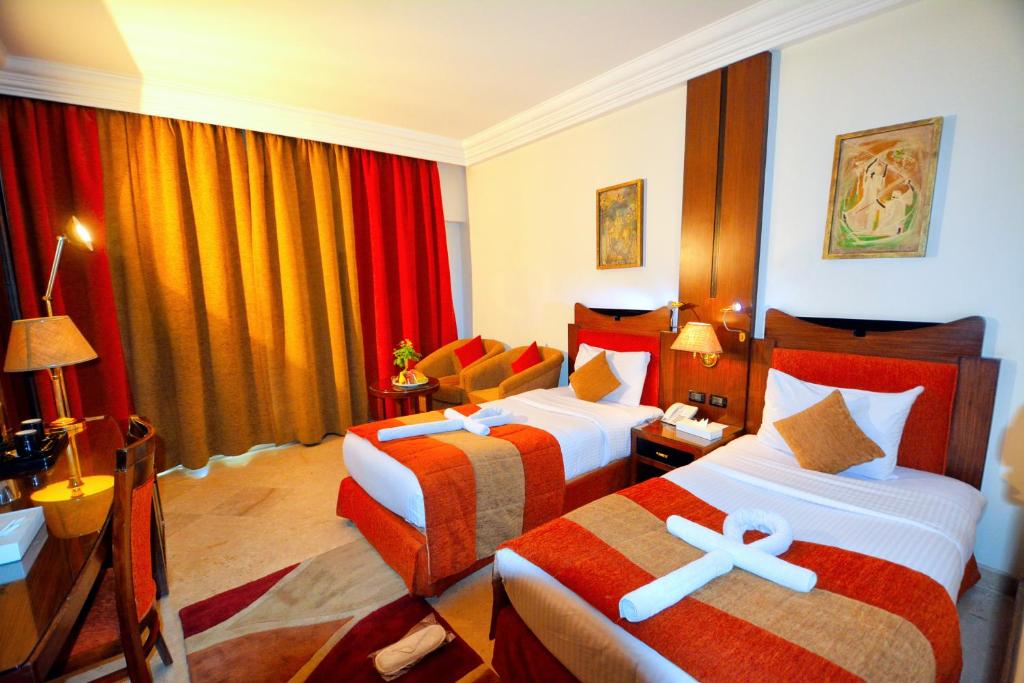 Postel nebo postele na pokoji v ubytování Aracan Eatabe Luxor Hotel