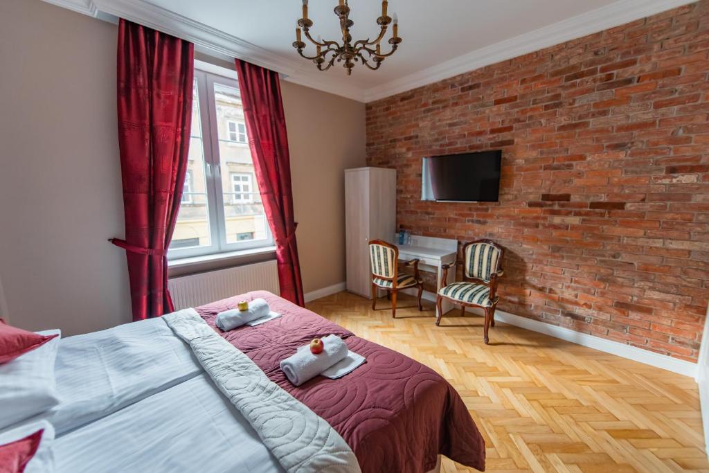 a bedroom with a bed with two teddy bears on it at Old Town Boutique Rooms in Lublin