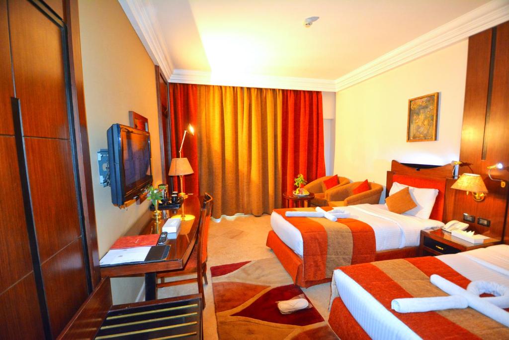 Postel nebo postele na pokoji v ubytování Aracan Eatabe Luxor Hotel