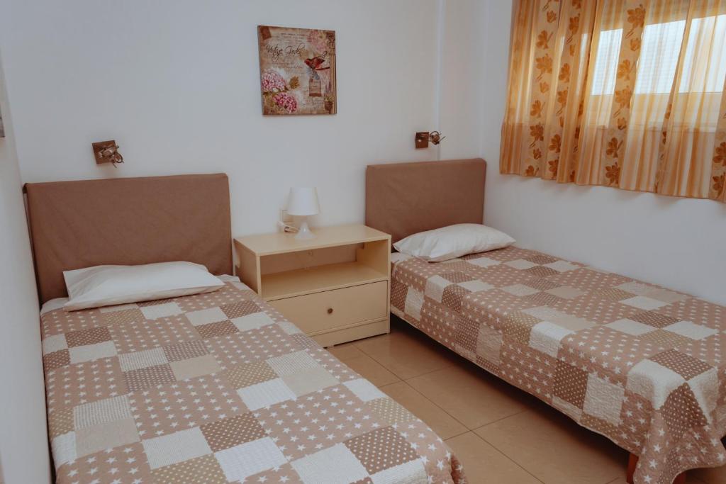 A bed or beds in a room at Sun Βy Τhe Sea 100m from the beach