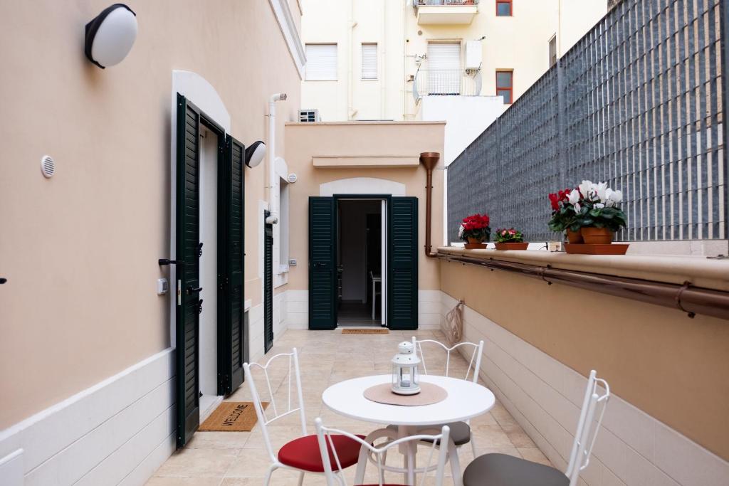 eine Terrasse mit einem Tisch und Stühlen auf dem Balkon in der Unterkunft Casa Patti 1 in Monopoli