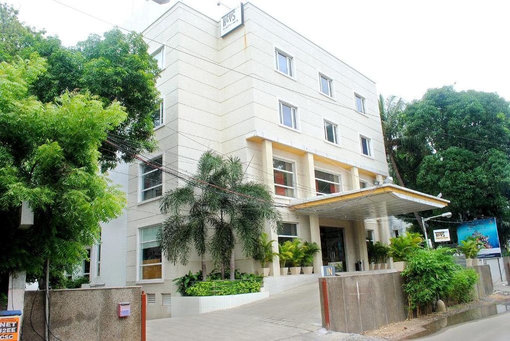 un gran edificio blanco con árboles delante de él en Keys Select by Lemon Tree Hotels, Katti-Ma, Chennai, en Chennai