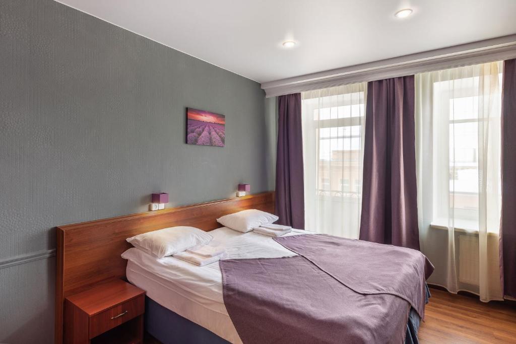 
A bed or beds in a room at RA Hotel at Tambovskaya 11
