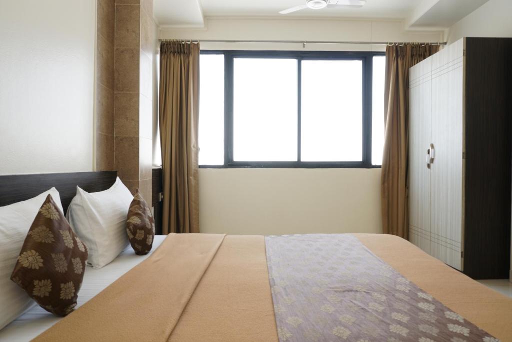Postel nebo postele na pokoji v ubytování Hotel Pavitra