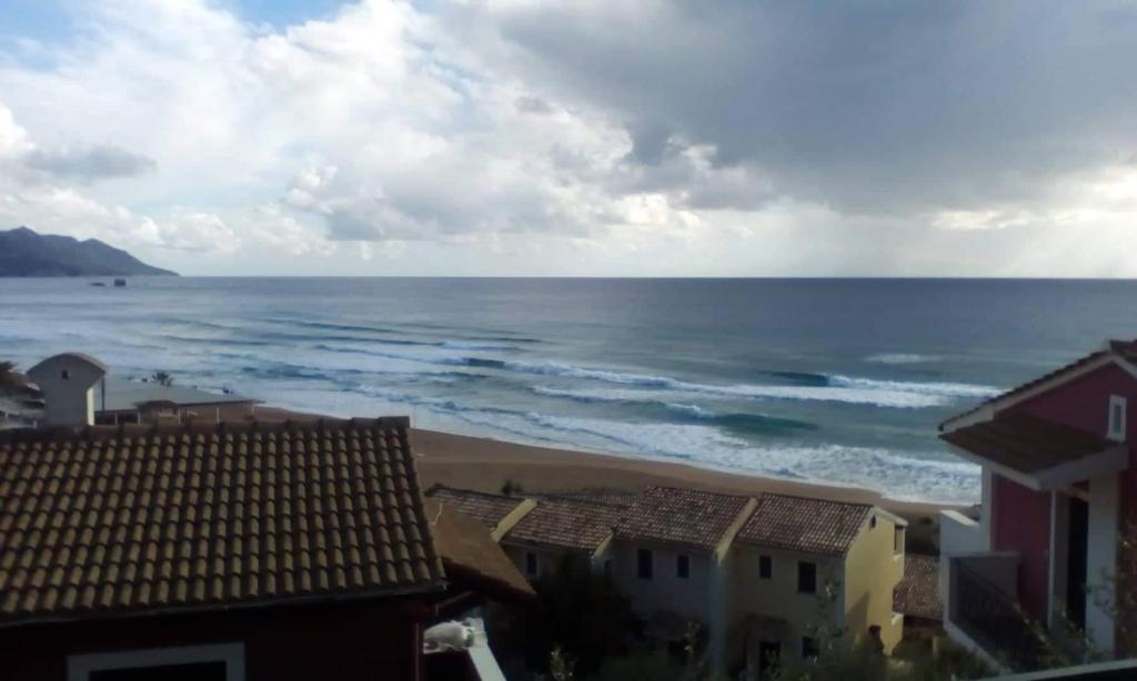a view of a beach with houses and the ocean at Glyfada Corfu Apartment in Glyfada