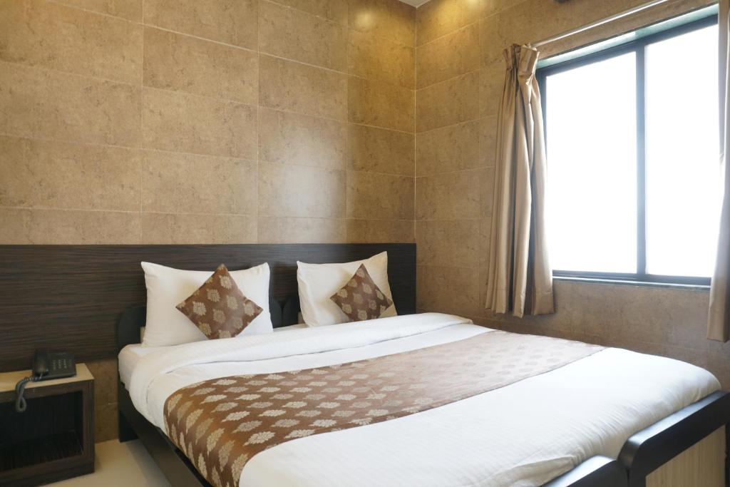 Postel nebo postele na pokoji v ubytování Hotel Pavitra