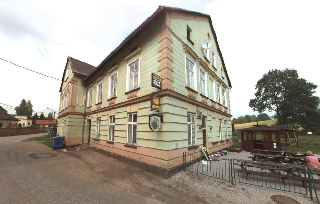 a large wooden building on the side of a street at Penzion Dalibor in Trutnov