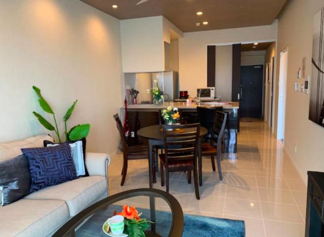 a living room with a couch and a dining room at Ocean Resort House 205 in Onna